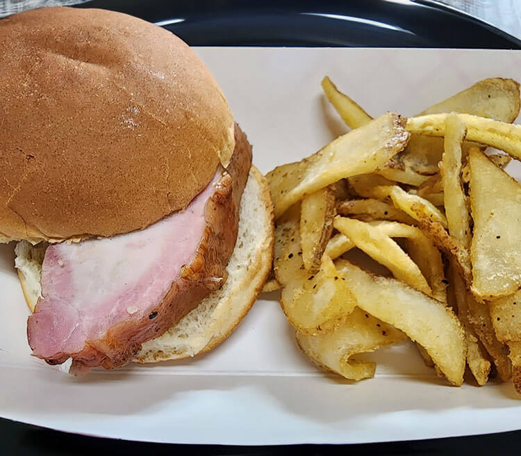 Hot meals, kid-friendly snacks, and farm desserts at Appleberry Orchard concessions including our Slow Pig Sandwich